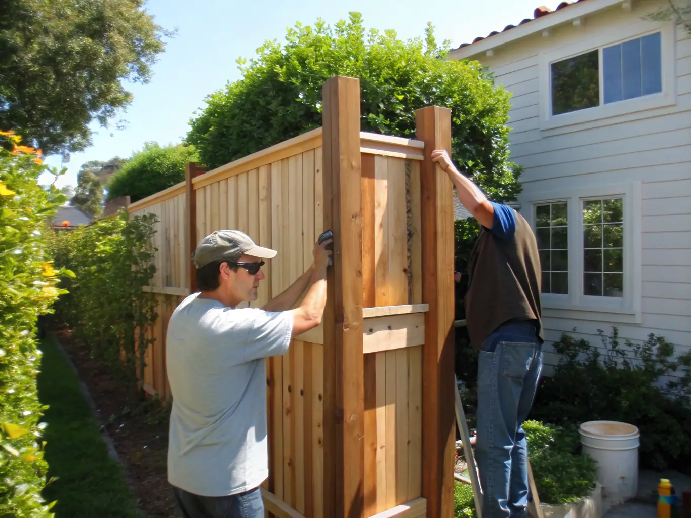 A close-up shot of a craftsman installing a custom wooden fence, showcasing the attention to detail and quality of work provided by RGE Services.